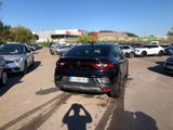 cars parked in a parking lot with a shadow of a person taking a picture