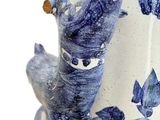 a blue and white vase with a bird on it