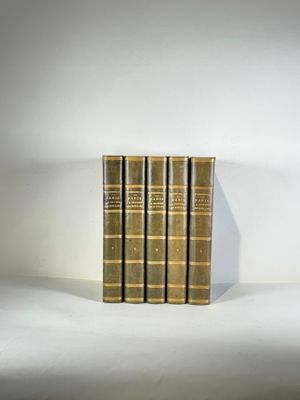 three books are stacked on top of each other on a white surface