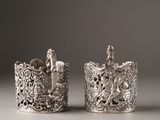 pair of antique silver napkin holders with figures on them