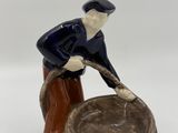 a figurine of a man with a bucket of water