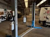 a picture of a garage with a couple of trucks parked in it