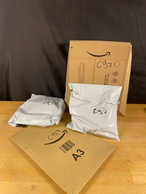 two bags of food sitting on a table next to a cardboard box