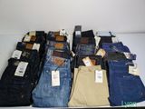 several pairs of men ' s jeans are stacked on a table