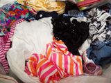 a pile of clothes in a plastic bag on the floor