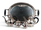 a silver tray with a silver tea set on it
