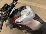 a close up of a motorcycle parked on the side of the road