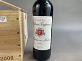 a bottle of wine that is next to a wooden box