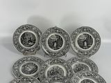 a set of twelve black and white plates with images of people on them