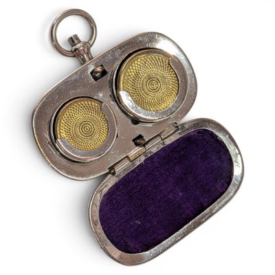 an image of a silver case with two yellow eyes inside of it