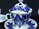 two cups and a saucer sitting on a table