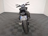 a motorcycle that is parked in a room with a checkered floor