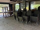 tables and chairs are lined up in a room with a metal roof