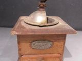 an old coffee grinder on display on a table