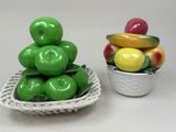 a bowl of apples and a bowl of bananas next to each other
