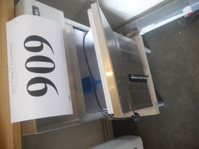 a sign on the door of a refrigerator in a room