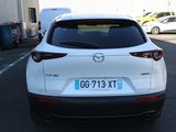 the back of a white mazda cx - hr parked in a parking lot