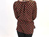 the woman is wearing a black and red shirt and black leggings
