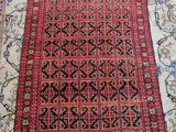 a red rug with black and white designs on it