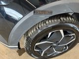 a close up of a car tire with a sticker on it