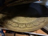 a gold plate sitting on top of a wooden table