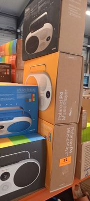 many boxes on the shelf of a store with a remote control