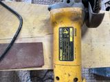 a yellow and black power tool sitting on a table