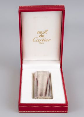 an image of a silver cigarette case in a red box
