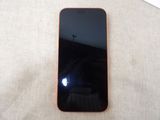an iphone with a black screen sitting on top of a table