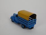 a blue toy truck with a yellow top on a white surface