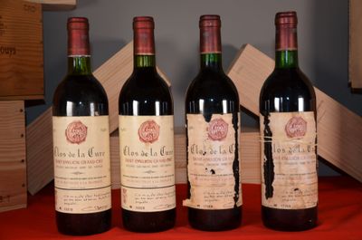 three bottles of wine sit on a red table cloth next to a wooden box