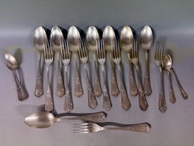 a lot of silver spoons and spoons on the table