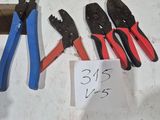 several pliers and pliers are sitting on a table next to a piece of paper