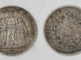 two silver coins, one of which is a woman and one of which is a man