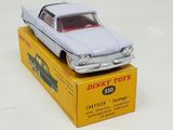 a white toy car sitting on top of a yellow box