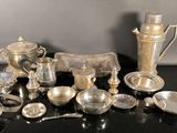 a lot of silver items sitting on a black table