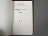 someone is holding a book open on a gray surface