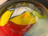 a glass bowl with a painting on it with words written on it