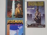 trois livres posés sur un mur blanc, avec une horloge et un clocher
