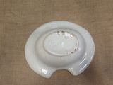 a white bowl with a hole in the middle of it
