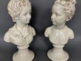pair of white porcelain busts of a boy and a girl