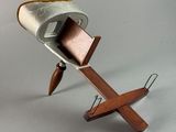 a wooden stand with a metal object on it