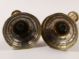 pair of antique brass candlesticks on a white background