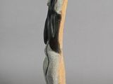 statue of a woman holding a bird on her arm