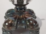 a glass bowl sitting on top of a metal stand