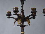 a candle holder that has a statue on top of it