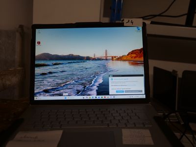 a laptop that is sitting on a desk in the dark