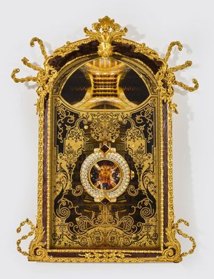an image of a gold clock with a crown on top of it