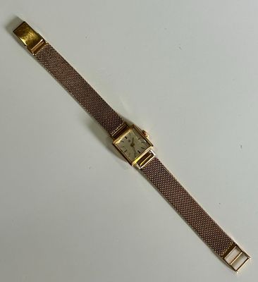 a close up of a wrist watch on a white surface