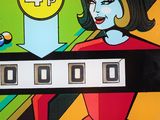 a pinball game with a woman playing a game